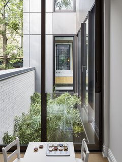 Natural wood and stone finishings reference the historic language of the factory. 