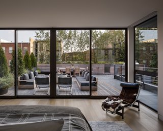 The fully glazed master bedroom opens onto a large rooftop terrace that overlooks Jersey City's Paulus Hook neighborhood.