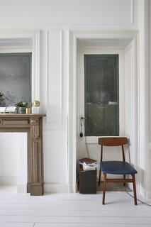 Wood, marble, natural stones, and linen are combined with candles, glass bottles, vases, clocks, and printed pillows to create a space that feels like a dreamy Belle Époque time capsule. 