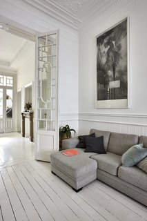 The bedroom, living room, dining area, and kitchen are lined up along one side of the apartment. Parallel to these rooms are another small bedroom and a bathroom.