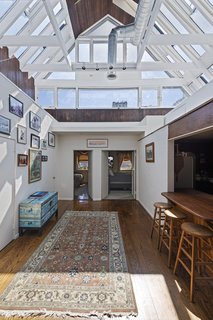 He transformed it to resemble a ship, with a double-height, glass-and-wood atrium that draws in plenty of sunlight. 