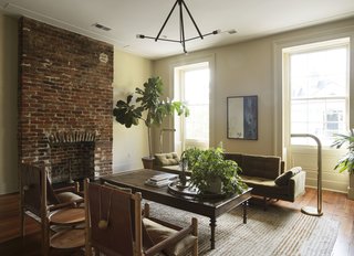 This room feautres an Adrian Pearsall sofa, Workstead Sling Chairs, an antique British colonial mahogany bed that is used as a coffee table, Workstead Lodge Chandelier 3, and Jim Bindman floor lamps.