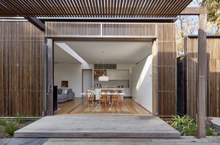 The addition has a skin of hardwood screens that offer protection from sunlight arriving from the north and west. The screens provide shade and privacy while still revealing views of the outdoor area and the pool.