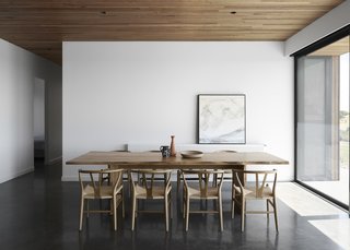 The house has floors of burnished concrete, providing thermal mass in the cooler months. The cement retains heat from the sun during the day and then slowly releases it back into the atmosphere to warm the interiors in the evening. 