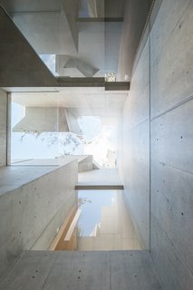 "The arrangement of functional volumes and voids, openings, and greenery integrates and entangles the building into a single organic whole," Hirata notes.