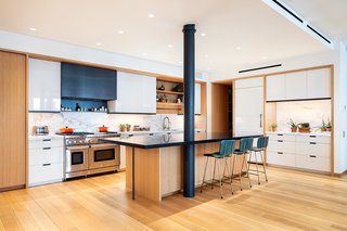 The original cast-iron supporting columns have been painted black to provide a striking contrast to the warm wood.