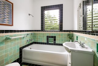 The art deco tiles in the bathrooms upstairs, as well as the original oak flooring and antique fixtures throughout the house, have all been carefully restored. 