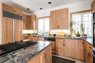 On the main floor, the kitchen is connected to a private bedroom and bathroom, making this an ideal space for guest quarters.