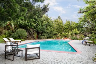 Beautiful french doors in the main living areas open out to the pool and lush gardens surrounding the abode.