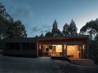 "The mono-pitch roof falls opposite to the stepping plan, creating a tall volume in the living room," says Hugh Maguire, co-founder of the firm. "This allows a high-level window to capture views of the high-forested horizon in the west."