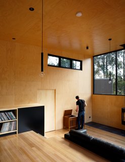 In the wide hallway between the kitchen and additional bedrooms is an entertainment and leisure space.