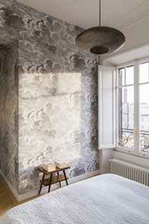 A large window brings in an ample amount of natural light into the bedroom.