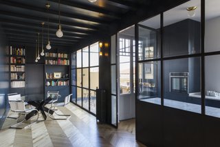 The bedroom door is painted the same dark color as the walls, making it almost imperceptible.