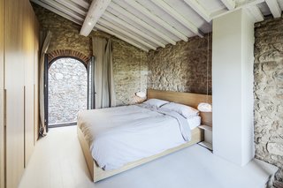  A wardrobe with wooden doors on the first floor bedroom contains and hides the shower and toilet. 
