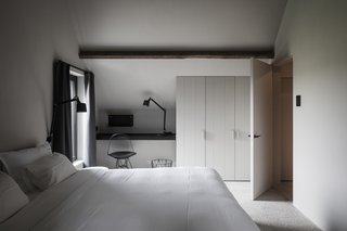 Reading and working spaces have been oriented toward an inner courtyard. A new subterranean passageway connects the transformed farmhouse with the enlarged barn.