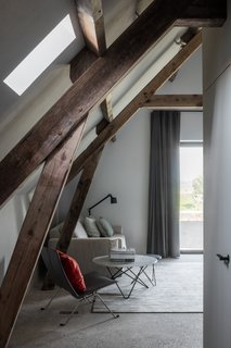 Rough, scrubbed concrete and rounder plastering contrast with the restored timber roof beautifully. 