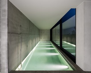 The indoor swimming pool now features a tall wall of glass.