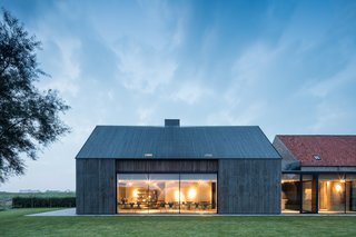 Incisions made in the façade amplify the contrast between the red and yellow brickwork.