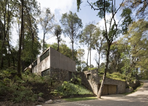 Concrete, stone, and glass have been combined to merge in with the surrounding landscape.