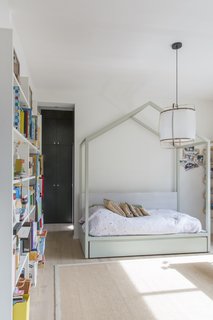 A glazed wall forms a corridor that leads toward the daughter's bedroom.
