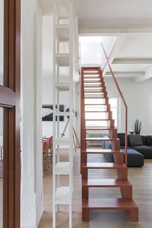 The pink staircase links the common areas in the lower level with the master bedroom above.