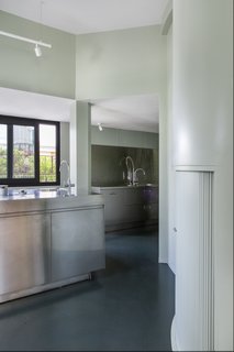 The kitchen has also been given a modern upgrade, now featuring stainless steel appliances.