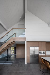  To create more unified interior spaces, Hope designed a lofty, open-concept foyer, living room, and dining area that looks out to the valley. 