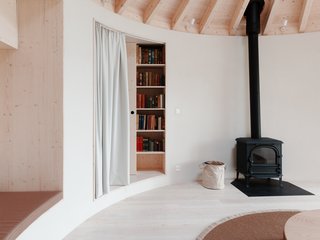 Beyond the main room is a bedroom that’s hidden from view with a curtain.
