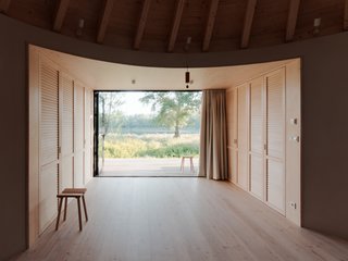 The large, rectangular entrance frames idyllic views of the surrounding countryside.