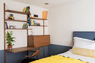 Royal System desk and shelving in walnut and brass.