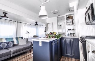 Benjamin Moore Blue Note defines the peninsula cabinets.