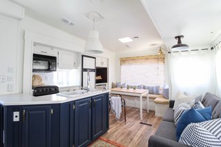 All of the cabinets and walls were professional-sprayed with Benjamin Moore Simply White, creating a crisp, modern look. The duo then sanded and wiped down the doors, primed them, and used Alkyd Satin paint for the final coating. 