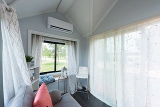 A large window and bench in the living area.