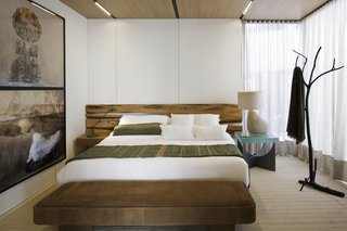 The bedroom features floor-to-ceiling windows with curtains for privacy.