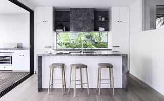Here is a look at the new kitchen with a glass backsplash that frames views of the forest.
