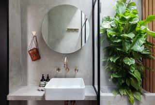 By reconfiguring the stairs as a switchback and locating it in the middle section of the house, the architects could fit a slim, tall bathroom between the switchback and the main bedroom. 