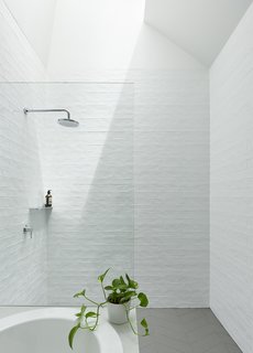The ceramic tiles were created with irregular glaze, which mimics the reflections of the harbor nearby. 