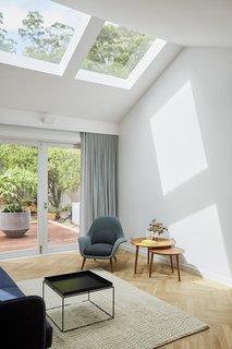 North-facing skylights were cut out from the roof to brighten the interiors and establish a visual connection to the bushy site.