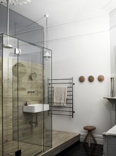 Furniture, decor, and artwork were kept to a minimum and carefully chosen to complement the pure and practical theme of the retreat. For instance, a transitional space with a window box daybed was created adjacent to the master bedroom as a buffer between the public and private areas, so a bedroom door wasn’t needed.