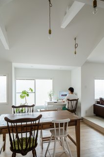 Dark, traditional, Japanese-style furniture were swapped for light, modern Lauan plywood built-in cabinetry that helped open up the living and dining areas.
