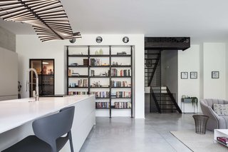 The iron staircase that weaves its way through the four floors has a decorative screen. 