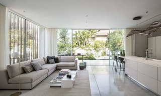 The screen helps to better ventilate the interiors. Shifting shadows cast patterns on the walls of the house as the western sun streams through the corridor.