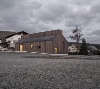 "The building’s envelope is developed as a thick wall, integrating multiple storage spaces, a secondary kitchen, and small ‘inhabitable’ window niches that carefully curate incoming light and expanding views to the surroundings," explains the project's architect, Aljoša Dekleva.