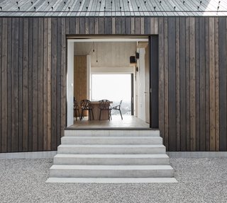  When the sliding doors are opened, the dining area appears as if it's a part of the outdoors.