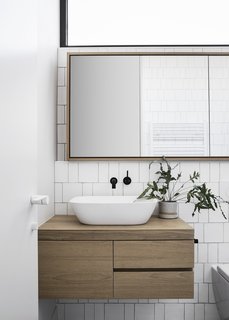 A new bathroom is located just before a step down to the living areas.