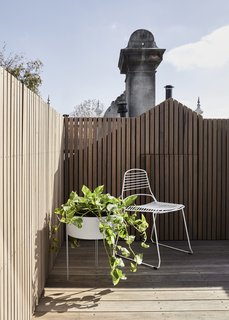 On the roof terrace is a casual chair and planter, which helps make this space a lovely spot to relax and soak up the Australian sunshine.