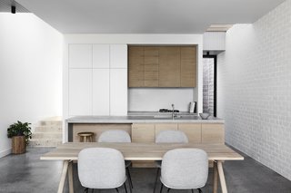 A simple color palette of gray, white, and brown gives the home a sleek, Scandinavian-inspired vibe.