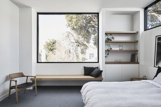 The bedroom on the upper level features a strategically placed window that frames vistas of the mountains and beyond.