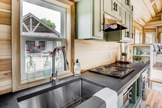 Concrete countertops and poplar wood finishings give the interiors a warm, cozy feel.