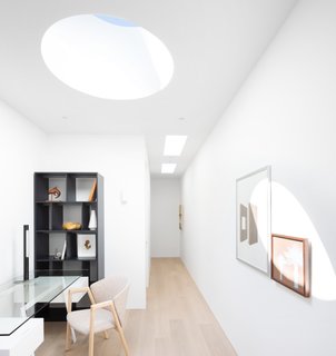 A crisp palette of toned woods and fresh white paint give the indoor and outdoor spaces a light and open feel.